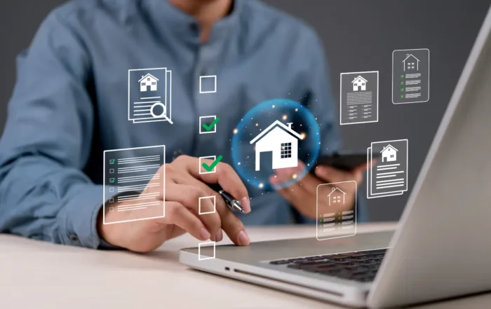 A real estate agent reviewing a digital dashboard on a laptop